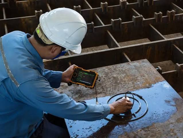 Technician using leak detection equipment